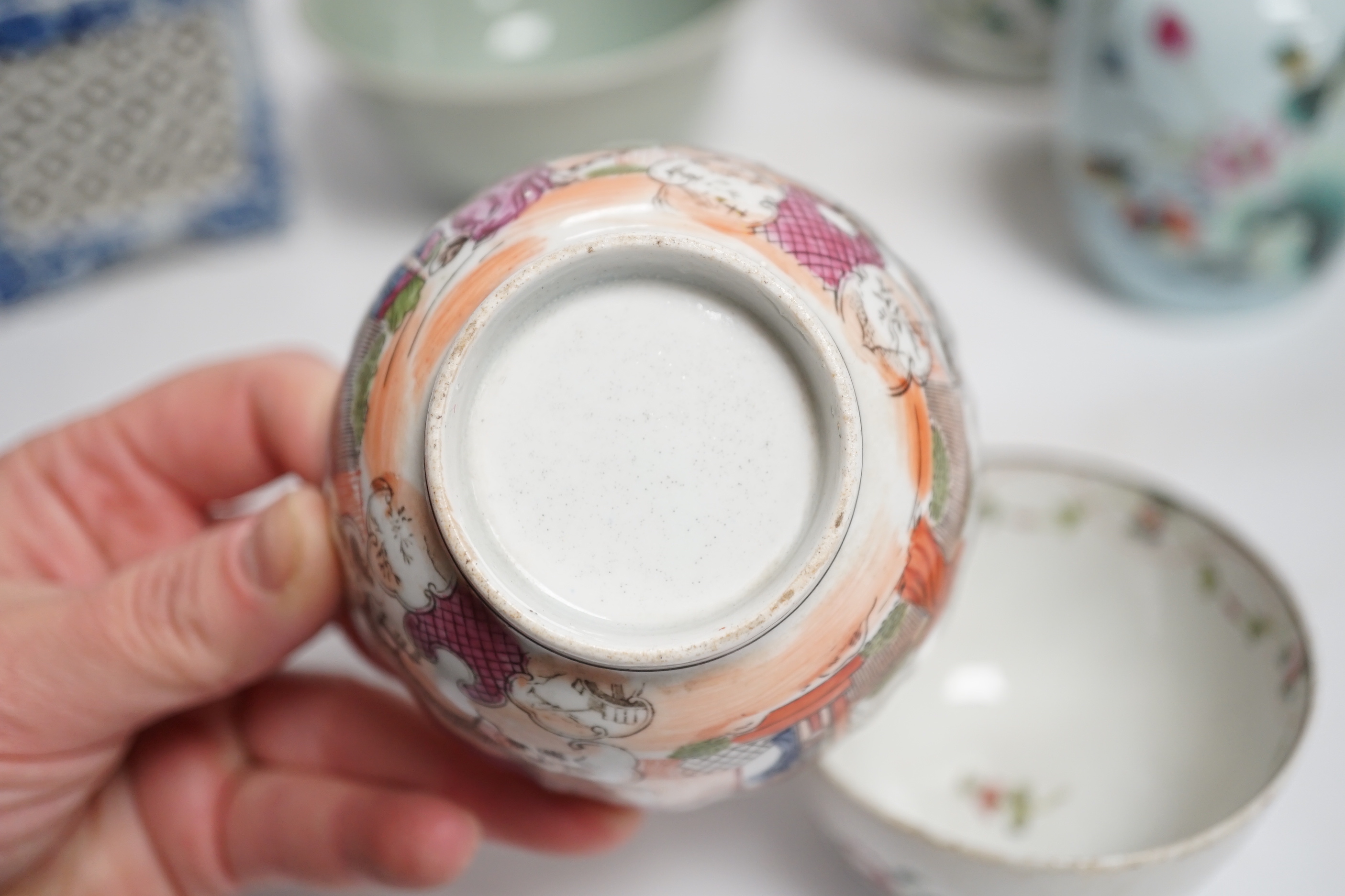 A collection of Chinese ceramics including celadon bowl decorated in low relief with fish, famille rose tea bowls and a jar, largest 12cm high